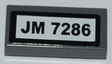 LEGO 3069pb0198 Tile 1 x 2 with &#39;JM 7286&#39; Pattern (Sticker) - Set 7286 - Main Product Image