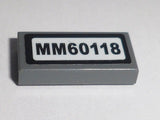 LEGO 3069pb0483 Tile 1 x 2 with &#39;MM60118&#39; Pattern (Sticker) - Set 60118 - Main Product Image