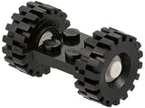 Black LEGO 2x2 modified plate assembly with two black 21mm D. x 9mm offset tread tires and white wheel hubs.