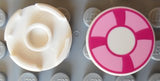 Top and bottom view of a LEGO 14769pb002 2x2 round tile with a magenta and bright pink life preserver pattern on a grey baseplate.