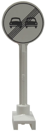 White LEGO road sign with a round gray 'end of no overtaking' pattern featuring two cars and a diagonal cross.