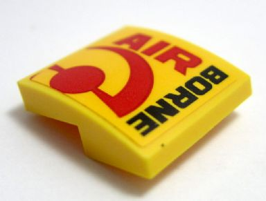 Yellow LEGO curved slope 2x2x2/3 brick with 'AIR' and 'BORNE' text and red circular logo pattern.