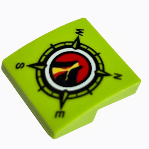 Lime green LEGO curved 2x2 slope with a compass design featuring N, E, S, W, and a red, yellow, black Volcano Explorers logo.