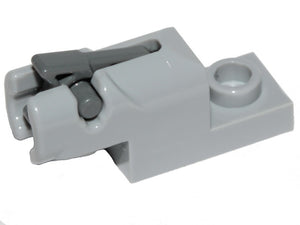 Light gray LEGO 1x2 mini blaster/shooter with a dark bluish gray trigger mechanism, viewed from the side.