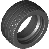 Dark gray LEGO Tire 24 x 12 Low (part 18977) showing detailed tread and inner rim, angled perspective.