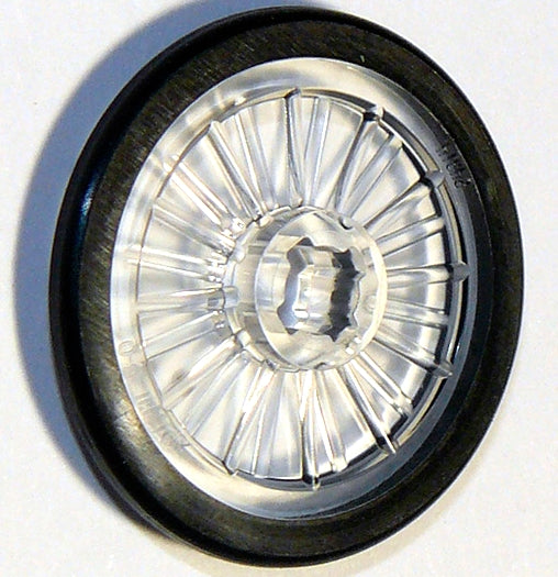 LEGO 24314pb01 wheelchair wheel with clear plastic hub, radial spokes, and molded black rubber tire pattern.