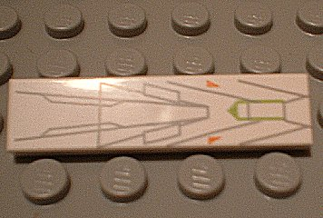 LEGO 2431px12 white 1x4 tile with gray lines, orange triangles, and a lime green cockpit outline, on a gray baseplate.