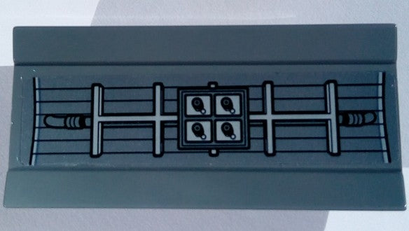 Gray LEGO 2440pb021 tile with a sticker showing the Millennium Falcon's radar pattern, featuring a central panel with four sensors.