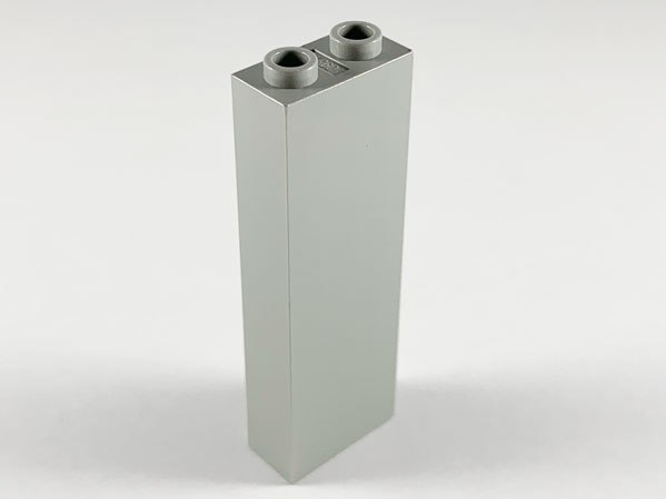 A single, light gray LEGO brick 1x2x5 standing upright on a white background, showing its two studs on top.