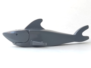 A grey LEGO shark with a pointed nose, debossed eyes, dorsal fin, and tail fin, against a white background.