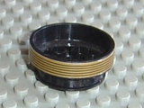 LEGO 2695pb01 wheel, 30mm D. x 13mm, black with a gold patterned band featuring black stripes, on a gray baseplate.
