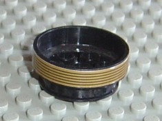 LEGO 2695pb01 wheel, 30mm D. x 13mm, black with a gold patterned band featuring black stripes, on a gray baseplate.