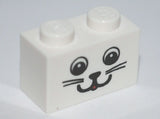 White LEGO 1x2 brick with a black cat face pattern, including two eyes, a nose, a smiling mouth, and whiskers.