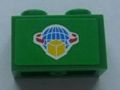 Green LEGO 1x2 brick with a sticker featuring a blue globe, a yellow box, and red arrows.