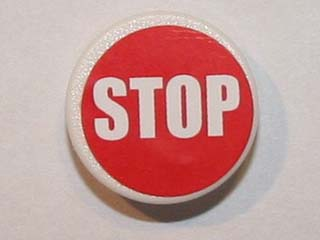 LEGO 2x2 round road sign with a white 'STOP' on a red background, featuring a white border.