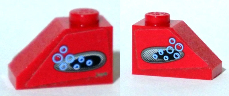 Two views of a red LEGO Slope 45 2x1 brick with a black vent and blue bubbles pattern on both sides.