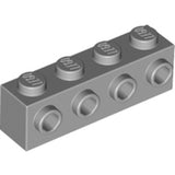 A grey LEGO 30414 modified brick, 1x4, with four studs on top and four hexagonal holes on one side.