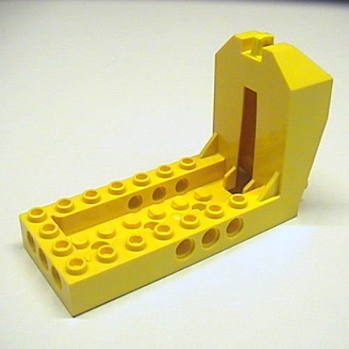 Yellow LEGO Cockpit 10 x 4 x 5 with Technic Holes, featuring a vertical slot and studded base.