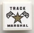 LEGO 2x2 white tile with black text 'TRACK MARSHAL', a gold star, and two checkered flags pattern.
