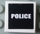 White LEGO 2x2 tile with a black background 'POLICE' sticker in white capital letters.