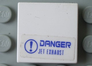 White LEGO 2x2 tile with a blue 'DANGER JET EXHAUST' sticker and exclamation mark symbol.