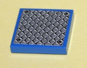 A blue LEGO 2x2 tile with a grey diamond tread plate pattern and four black rivets.