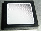 Black LEGO 2x2 tile with a white and black dotted pattern resembling a vehicle mirror, featuring rounded corners and a small border.