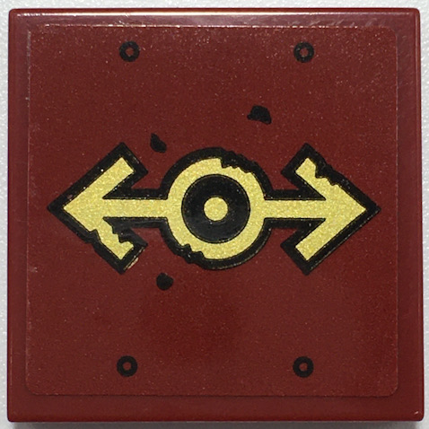 Red LEGO 2x2 tile with gold train logo and black outline, featuring four small black circles and speckles.