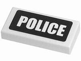 White LEGO 1x2 tile with 'POLICE' written in white text on a black background pattern.