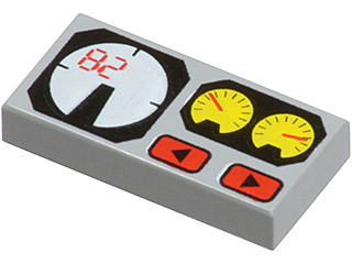 A light gray LEGO 1x2 tile with a printed pattern featuring a white gauge with red '82', two yellow gauges, and two red buttons.
