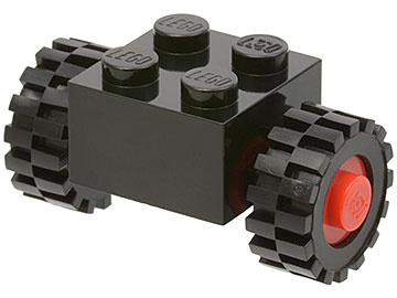 Black LEGO modified 2x2 brick with four studs, assembled with red wheels and black 15mm D. x 6mm offset tread tires.