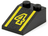 Black LEGO slope 3x2 brick with yellow number 4 and double lines pattern on a textured surface