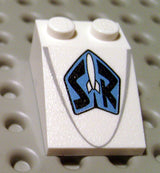 White LEGO Slope 33 3 x 2 with a blue shield pattern featuring a white rocket and black 'SR' letters, and a faint grey line.