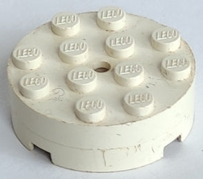 A perfectly round, white LEGO 4x4 turntable top with 12 studs, each embossed 'LEGO'. The part shows some minor wear.