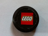 Black LEGO sports hockey puck, large, with the iconic white LEGO logo on a red square in the center.