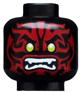 Black LEGO minifigure head with dark red alien face decorations, lime green eyes, and white fangs.