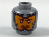Gray LEGO minifigure head with orange face, dark red eyebrows, cheek lines, and stubble, framed by a gray balaclava print.