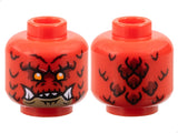 Red LEGO minifigure head 3626pb3783 with alien dragon face, orange eyes, dark tan chin, sharp teeth, and scales.