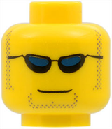 Yellow LEGO minifigure head with black sunglasses, dark blue lenses, dark tan sideburns and goatee stubble, and a grin.