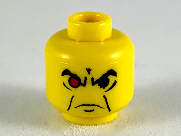 Yellow LEGO minifigure head with an angry expression, featuring black eyebrows, a furrowed brow, a downturned mouth, and one red eye.