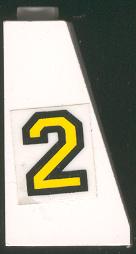White LEGO Slope 75 2 x 2 x 3 with yellow number 2 with black outline sticker on its right side.
