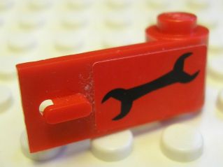 Red LEGO 3821pb019 Door 1x3x1 Right with a black wrench sticker, part of Set 8147, resting on white studs.