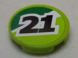 Lime green round LEGO 2x2 tile with a green sticker featuring a black number 21 outlined in white.
