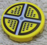 Round yellow LEGO 2x2 tile featuring a gray cross pattern and black dots arranged in four quadrants, resembling a sticker.