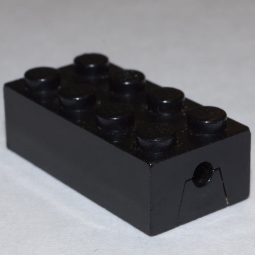 A single black LEGO 2x4 modified brick with 8 studs, featuring a wheels holder cutout on one end.