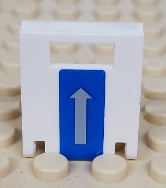White LEGO container 2x2x2 door with a slot, featuring a blue sticker with a gray vertical arrow pointing upwards. Part stands on a tan baseplate.