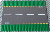 LEGO 44336pb01 Road Baseplate 32x32, dark gray road, white & yellow dashed lines, light gray storm drains, green studs.