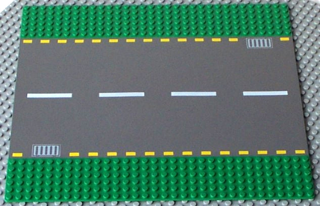 LEGO 44336pb01 Road Baseplate 32x32, dark gray road, white & yellow dashed lines, light gray storm drains, green studs.