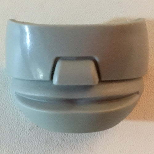 Close-up of a light gray LEGO Sports Hockey Mask 4 with Glasses piece, featuring a curved top and bottom with a central protrusion.