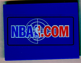 A blue LEGO 6x8 slope brick with a rectangular sticker displaying the white and red NBA.COM logo, including the player silhouette.